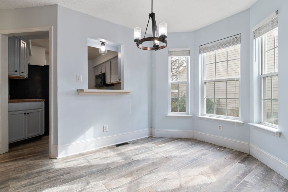 empty residential dining area with windows and natural light