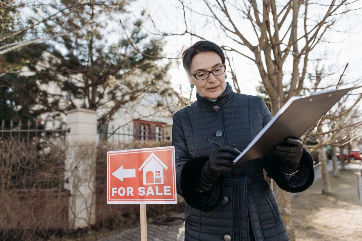 a professional appraiser reviewing property documents and measurements during a home appraisal