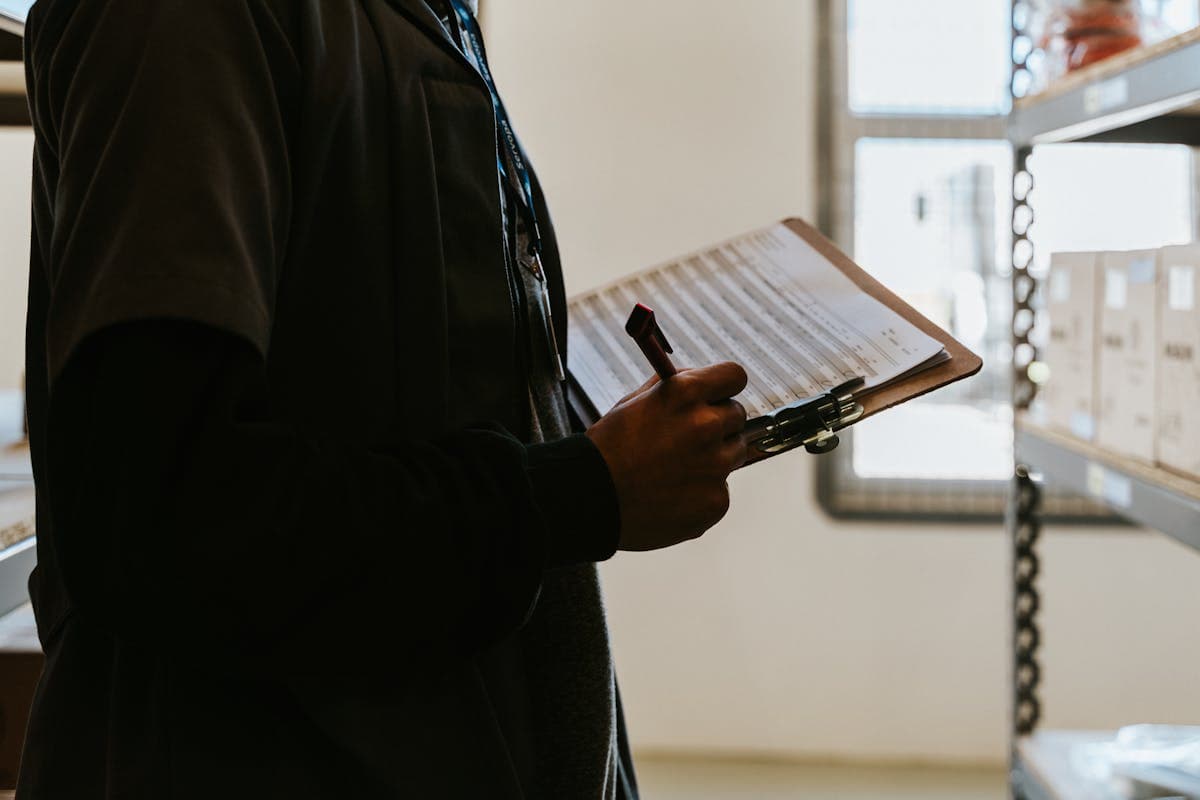 professional home inspector examining a modern property with a clipboard and flashlight