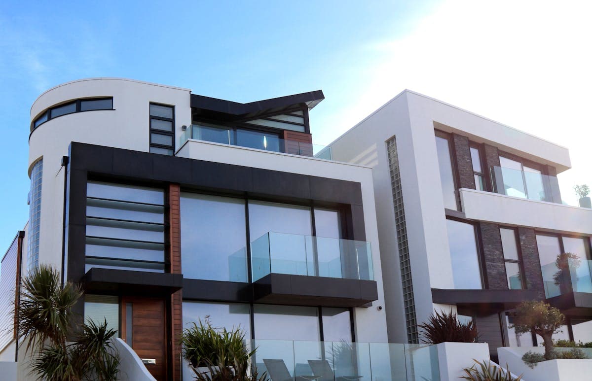 Modern residential buildings against a city skyline, representing real estate investment opportunities