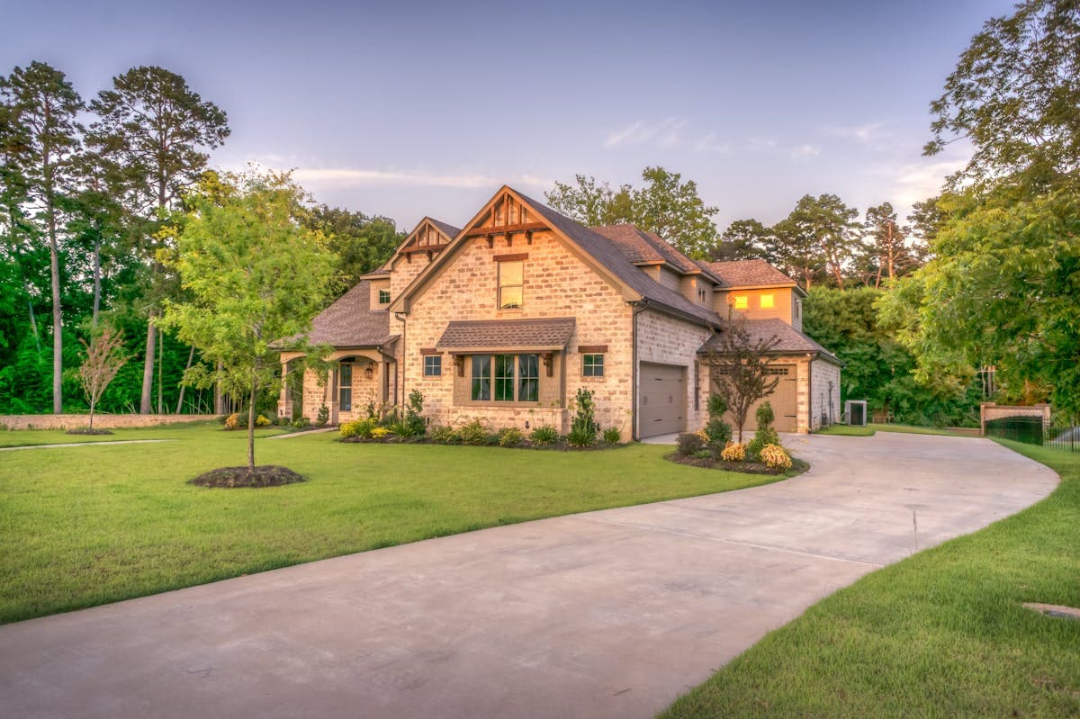 well-maintained suburban home with manicured landscaping at golden hour