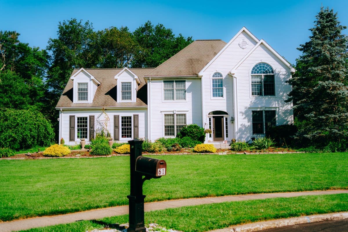 well-maintained family home with a green lawn on a sunny summer day
