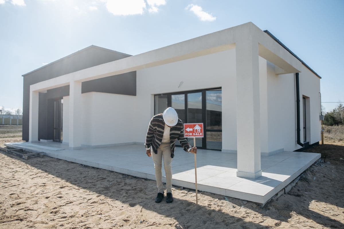 real estate agent photographing a home exterior with a smartphone for social media