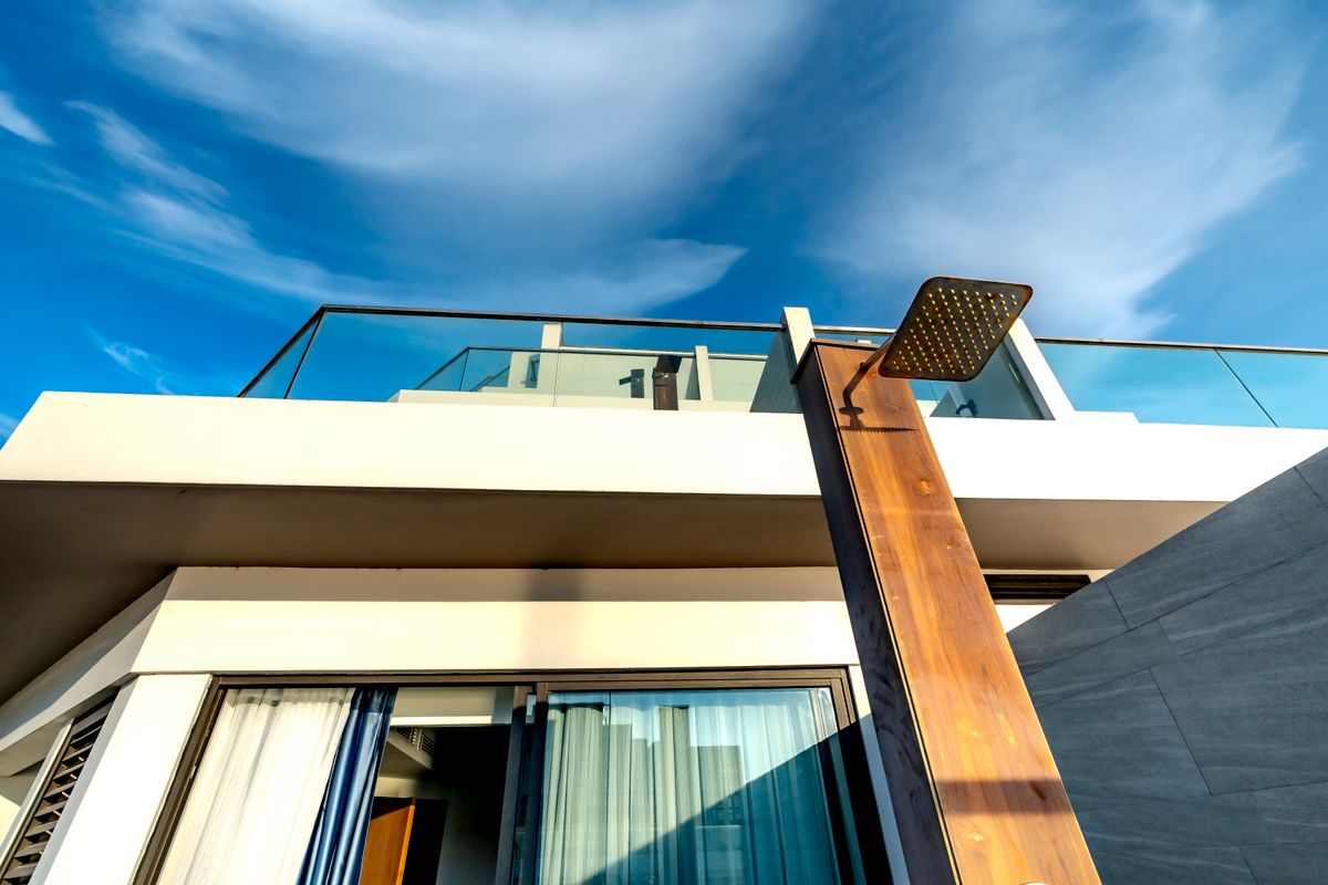 modern luxury home with large windows and landscaped front yard