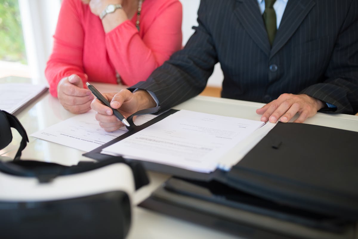 calculator and financial documents on a desk showing budgeting for home purchase expenses