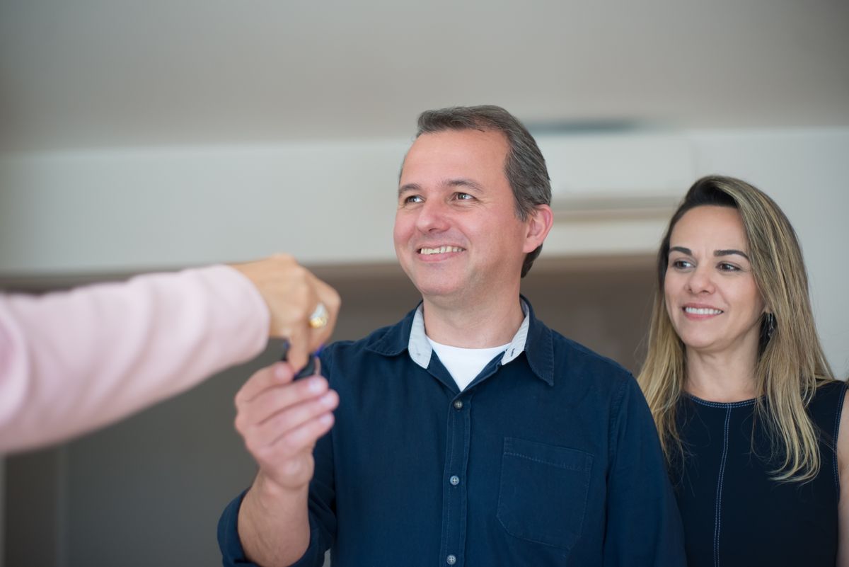 Agent speaking with a homeowner in a bright living room