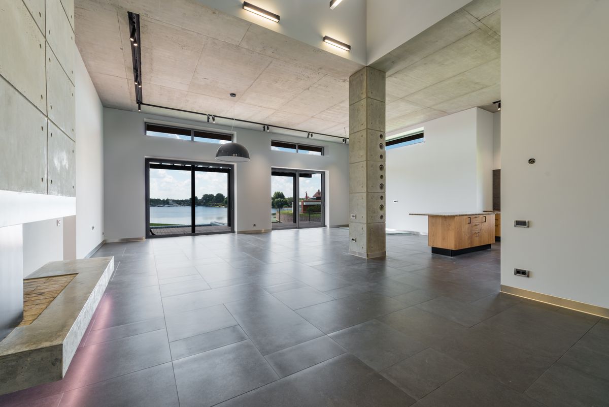 empty contemporary open-plan interior with a kitchen island and large windows