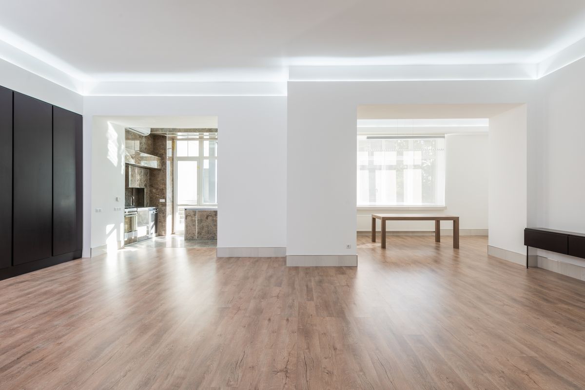 open modern residential interior with wood flooring and a bright dining area
