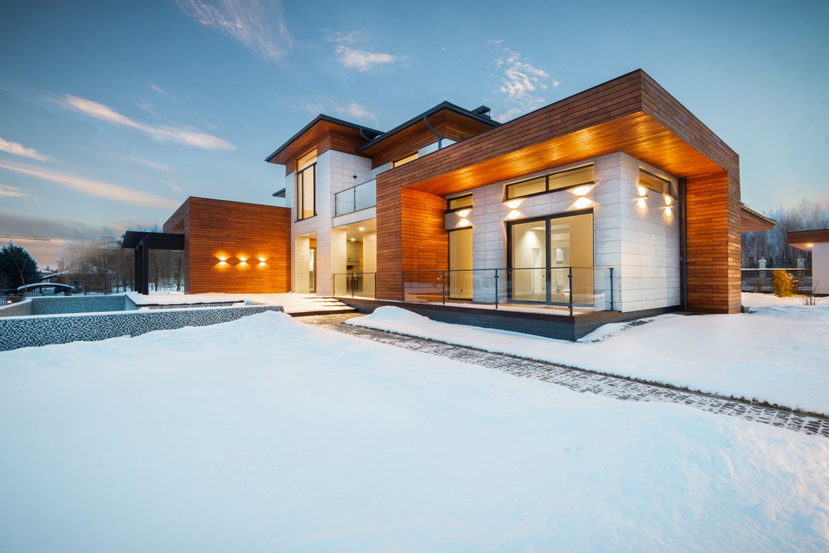 modern wood-clad house exterior in a snow-covered landscape
