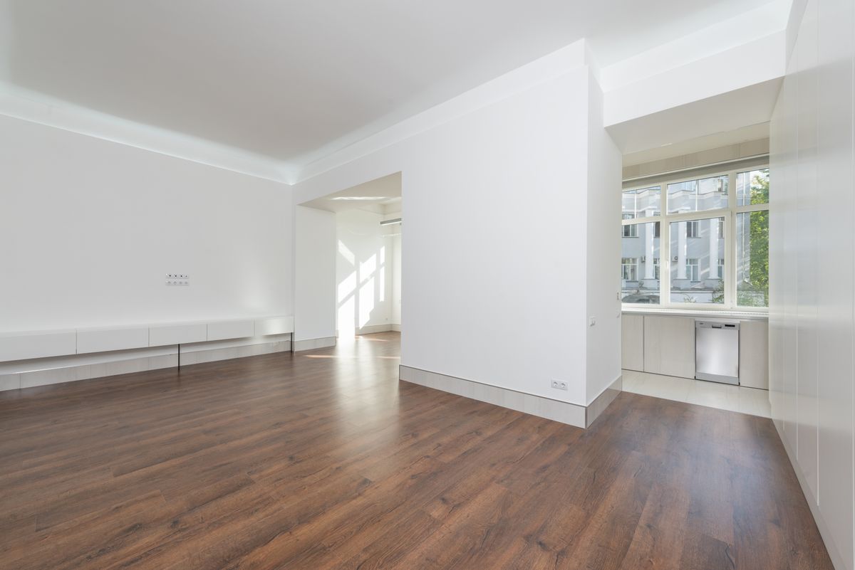 unfurnished apartment interior with a compact kitchen and wood flooring